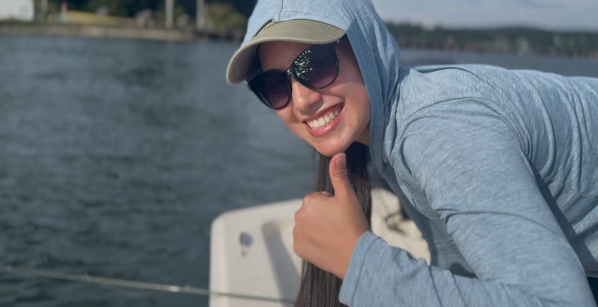 A member giving a thumbs-up from the boat